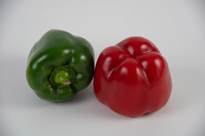 A red and a green bell pepper